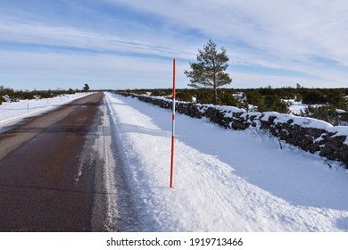 Red Snow Marker By Roadside In A Great Plain Landscape