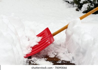 Red Snow Shovel Scooping Snow.