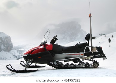 Red Snowmobile In Front Of Sella Group Mountains. Sella Ronda. Selva Gardena. Dolomite Alps. South Tirol. Italy