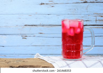 Red Soda In Glass Put On Wood Background.