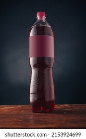 Red Soda Pop Bottle With Blank Label On Dark Wooden Background, Template Mockup No Brand Advertising, Fresh Berry Drink