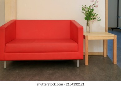 Red Sofa And Small Wooden Table