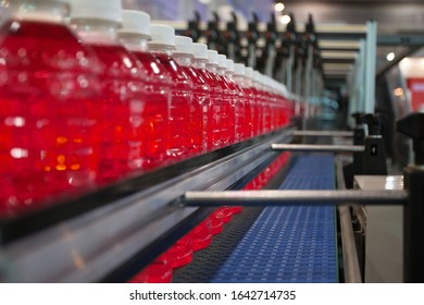 Red Soft Drink transfer on Conveyor Belt System. - Powered by Shutterstock