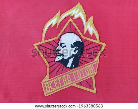 Red soviet flag with the image of Lenin and inscription in Russian 