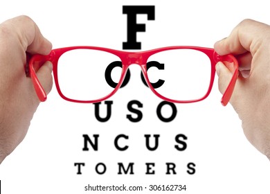 Red spectacles focusing on text focus on customers arranged as eye chart test