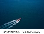 Red speed boat fast movement on the water top view. Top view of a red fast boat. Diagonal boat movement on blue water top view. Travel - image.