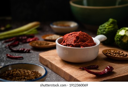 Red Spicy Curry Paste On Dark Background With Herb Ingredients  - Thai Food