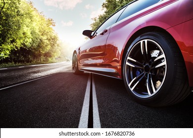 Red sport car on the asphalt road