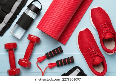 Red sport equipment on wooden background, top view - Powered by Shutterstock