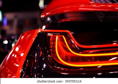 Red sport hybrid car rear light parts by night. Tail light of luxury sport car