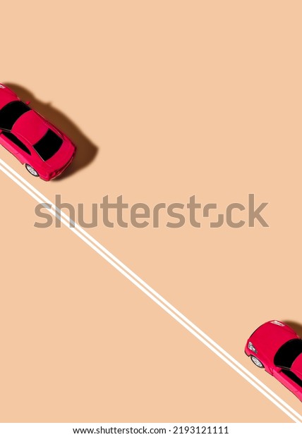 Red\
sports car near solid lines on a beige\
background.