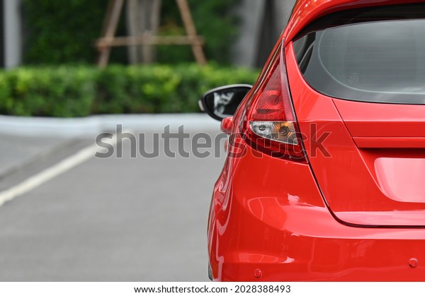 Red sports car rear lights with green natural\
light European cars in\
Thailand