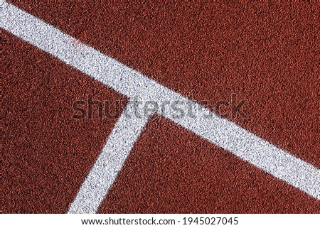 Red sports court or playground background with white line. Artificial rubber coating for playgrounds and sports places.