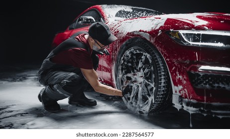 Red Sportscar's Wheels Covered in Shampoo Being Rubbed by a Soft Sponge at a Stylish Dealership Car Wash. Performance Vehicle Being Washed in a Detailing Studio - Shutterstock ID 2287564577