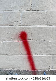 Red Spray Paint Line Swoosh On A White Painted Urban Brick Wall