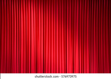 red stage curtain with light spots - Shutterstock ID 576973975