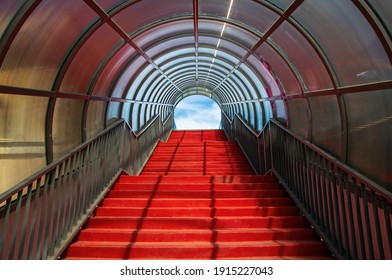 Red staircase with arched roof. Ascending forward to the sky. Modern architecture concept