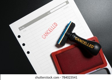 Red Stamp With Text Cancelled On Business To Do List Table On Black Background. Reminder To Cancel Business Appointment. Business Cancelled Rejected Abort Declined Cancellation Denied Concept.