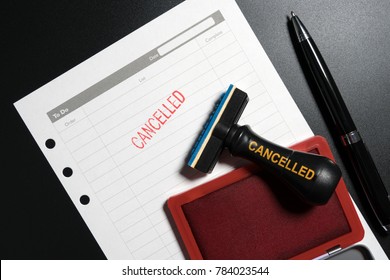 Red Stamp With Text Cancelled On Business To Do List Table On Black Background. Reminder To Cancel Business Appointment. Business Cancelled Rejected Abort Declined Cancellation Denied Concept.