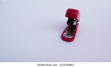 Red Stapler On A White Background.
