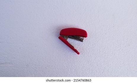 Red Stapler On A White Background.
