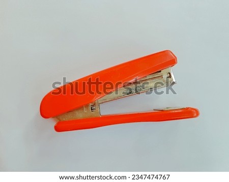 red stapler on white isolated background 