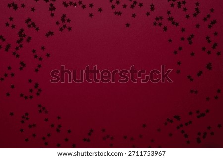 Red star confetti pops dramatically against a rich purple background, creating a bold and modern festive visual. Eye-catching Christmas advertisements, text-overlay graphics, and contemporary greeting