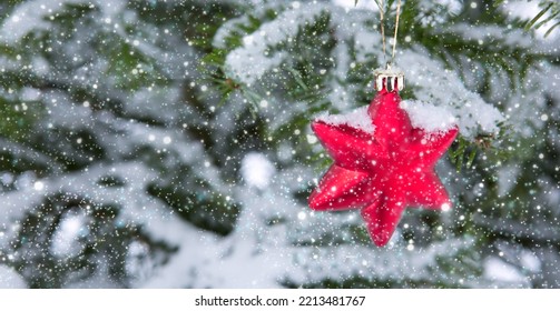 Red Star On Snow Covered Pine Branch .Christmas Background.