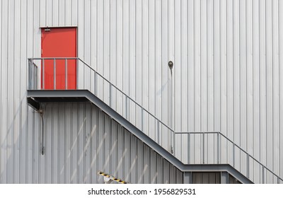 Red Steel Emergency Door And Fire Exit Stair Of Factory. Metal Fire Exite Stair.