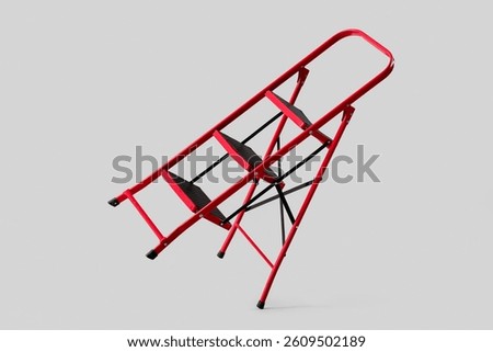 Red stepladder on light background