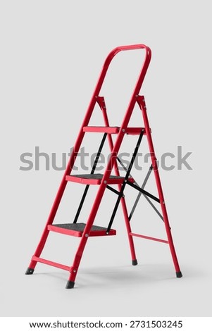 Red stepladder on light background
