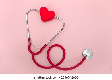 Red Stethoscope And Red Heart Shape On Pink Background , Heart Healthcare Medical Concept