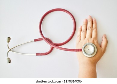 red stethoscope medical device on white background - Shutterstock ID 1170814006