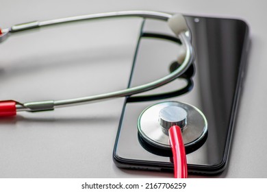 Red Stethoscope On Black Smartphone Represents Health Records And Digital Patient Records With Mobile Devices For Digital Doctors And Digital Diagnostic Treatment With Modern Equipment And Technology