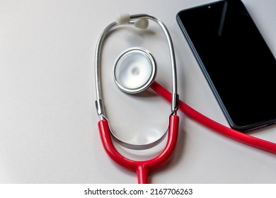 Red Stethoscope On Black Smartphone Represents Health Records And Digital Patient Records With Mobile Devices For Digital Doctors And Digital Diagnostic Treatment With Modern Equipment And Technology