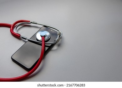 Red Stethoscope On Black Smartphone Represents Health Records And Digital Patient Records With Mobile Devices For Digital Doctors And Digital Diagnostic Treatment With Modern Equipment And Technology