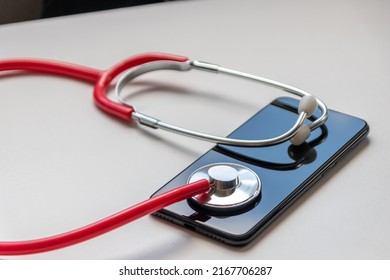 Red Stethoscope On Black Smartphone Represents Health Records And Digital Patient Records With Mobile Devices For Digital Doctors And Digital Diagnostic Treatment With Modern Equipment And Technology