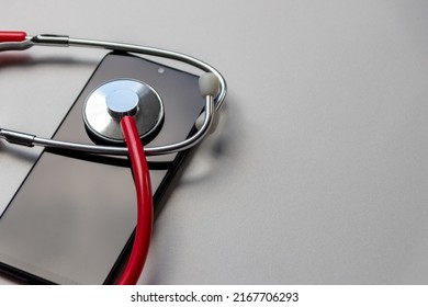 Red Stethoscope On Black Smartphone Represents Health Records And Digital Patient Records With Mobile Devices For Digital Doctors And Digital Diagnostic Treatment With Modern Equipment And Technology