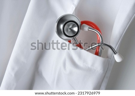 Red Stethoscope in white doctors coat close up