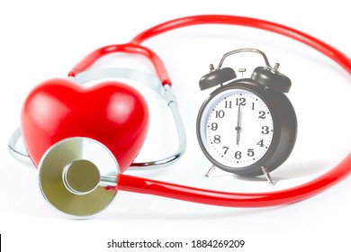 Red Stethoscope,shape Heart and clock Isolated On White Background.Blood pressure control-Health care concept