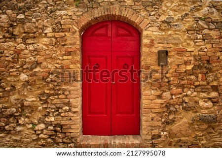 
red stone wall door in medieval italian town