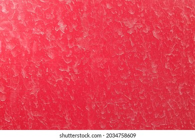 Red stone wall with white splotches of dirty water stains