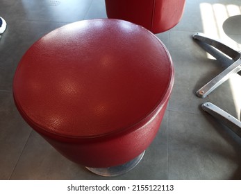 A Red Stool With Leather Cover