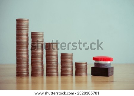 Red stop reset emergency button with stack coins as graph chart falling down background on wooden table copy space. Stop reset recession economy, global world economic crisis, FED control inflation.