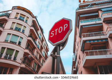 red stop sign between two houses
