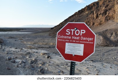 Red Stop Sign In The Death Valley, Hot Desert Against The Backdrop Of Mountains, US National Park