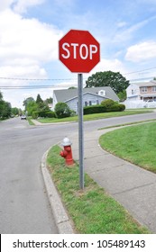 Red Stop Sign And Fire Hydrant On Suburban Neighborhood Street Corner