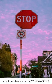 Red Stop Sign With No Parking Sign On Capitol Hill, Seattle Neighborhood Street During Pink Sunset