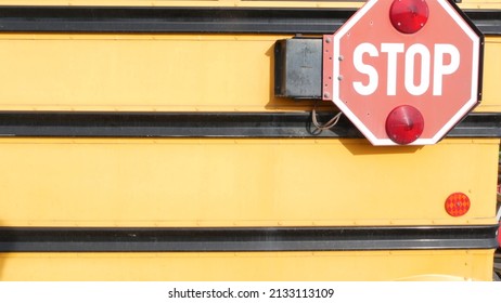 Red Stop Sign, Yellow School Bus In California, USA. Traffic Warning On Passenger Schoolbus Or Shuttle In America. Public Transportation Safety On Road. Caution Or Attention Signage. Education Concept