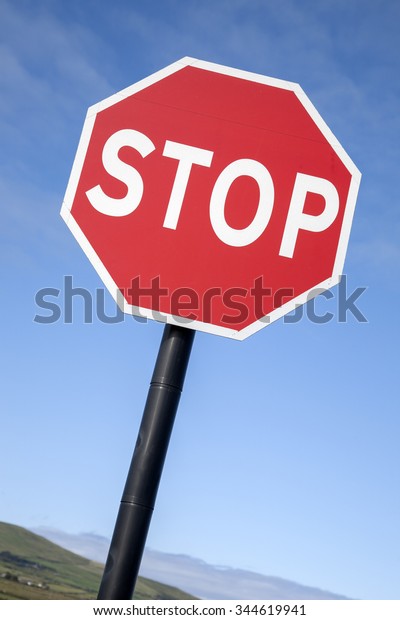 Red Stop Traffic\
Sign on Blue Sky Background
